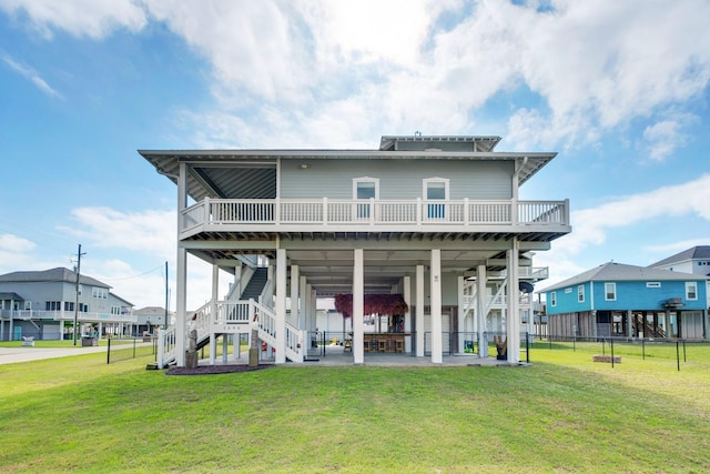 back of house featuring a patio, stairway, a wooden deck, and a lawn