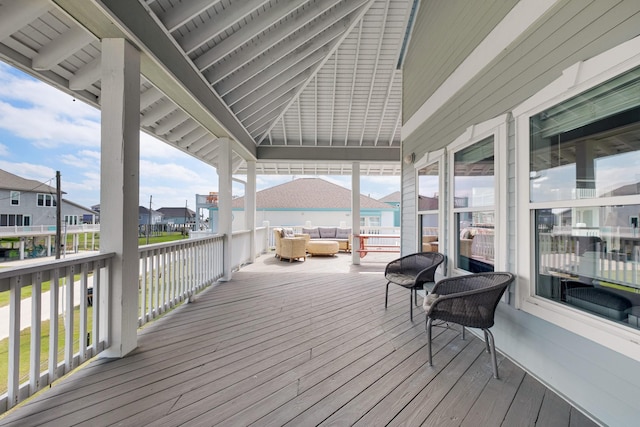 wooden terrace featuring a residential view and an outdoor living space