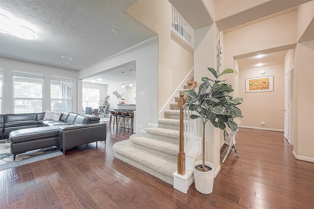 interior space featuring hardwood / wood-style flooring and a textured ceiling