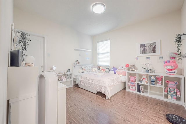 bedroom with wood-type flooring