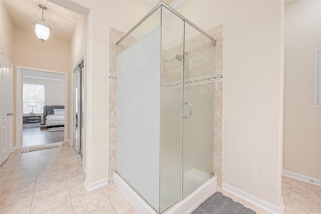 bathroom featuring tile patterned flooring and a shower with shower door