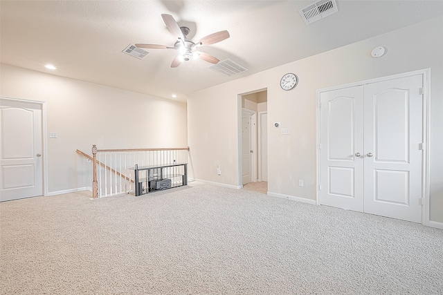 spare room with ceiling fan and carpet flooring