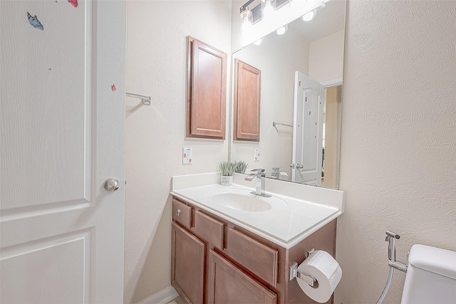 bathroom with toilet and vanity