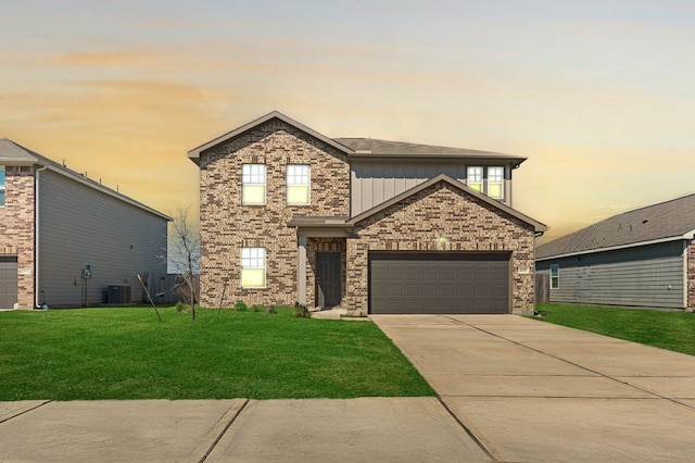 view of front of home with a garage, brick siding, concrete driveway, a front lawn, and board and batten siding