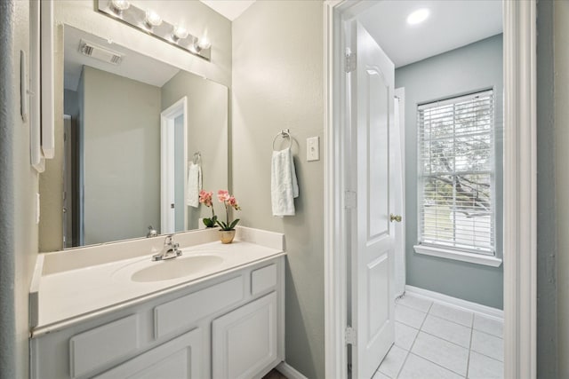 bathroom with tile patterned floors and vanity