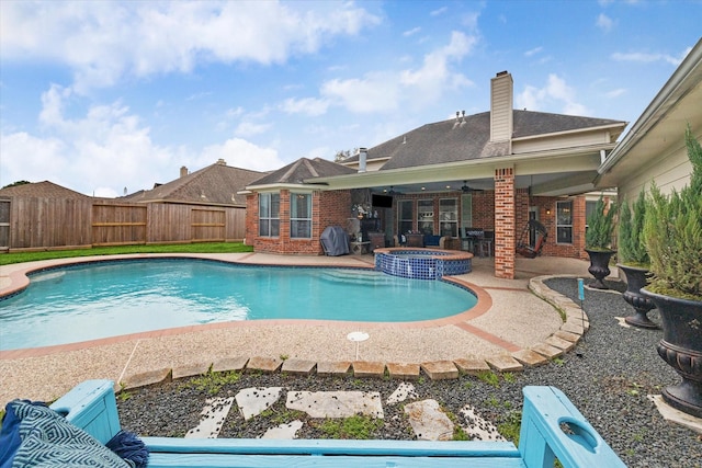 view of swimming pool with grilling area, an in ground hot tub, ceiling fan, and a patio area