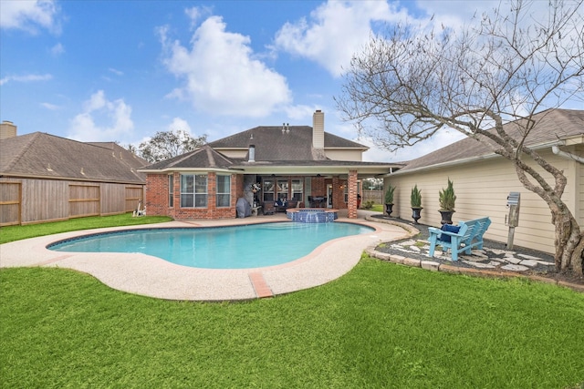 view of swimming pool with a yard and a patio area