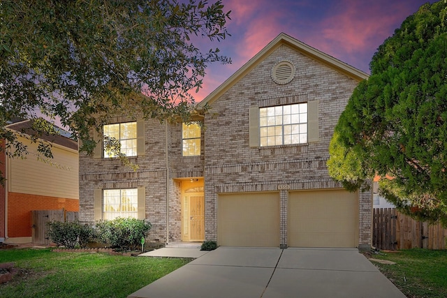 front of property with a garage and a lawn