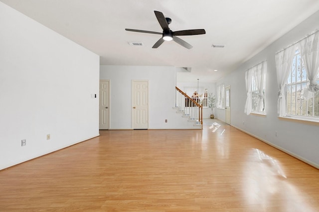 unfurnished living room with light wood-type flooring and ceiling fan