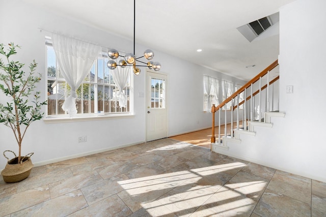 foyer entrance with a chandelier