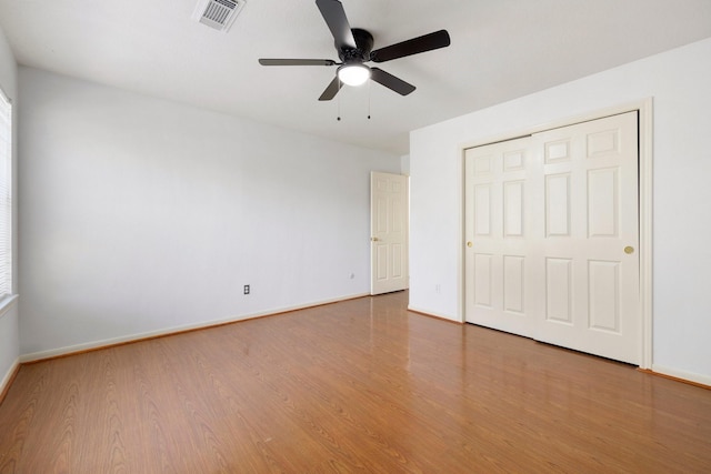 unfurnished bedroom with a closet, ceiling fan, and wood-type flooring