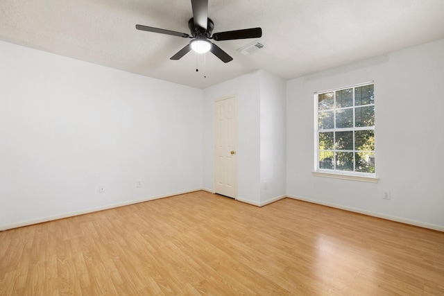 unfurnished room with light wood-type flooring, ceiling fan, and a textured ceiling