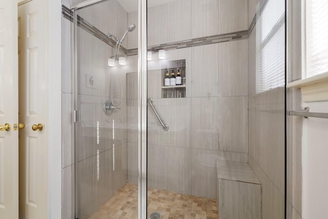 bathroom with a shower with door