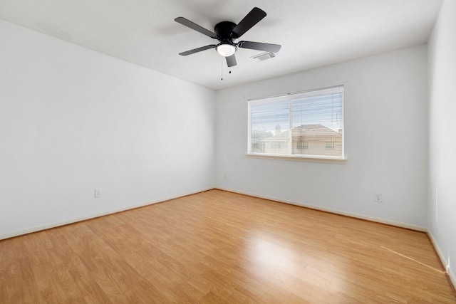 empty room with ceiling fan and light hardwood / wood-style floors