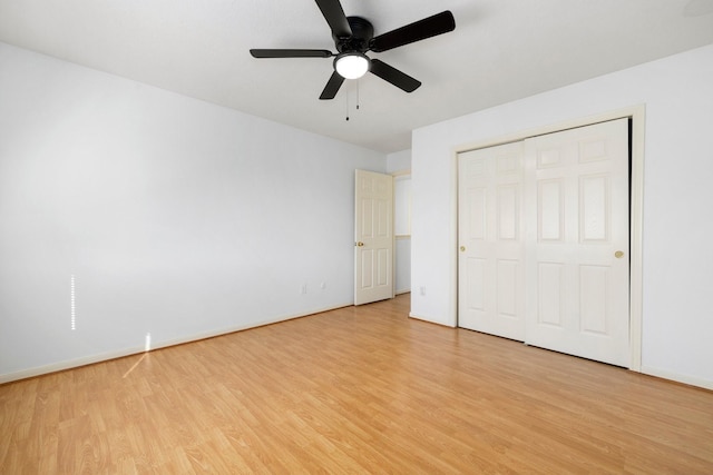 unfurnished bedroom featuring light wood-type flooring, a closet, and ceiling fan