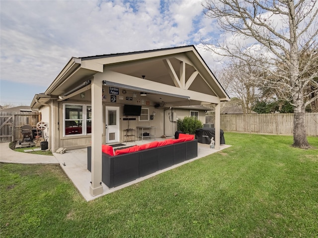 rear view of property with outdoor lounge area, a lawn, and a patio area