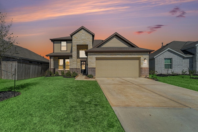 view of front of house with an attached garage, fence, a front lawn, and concrete driveway