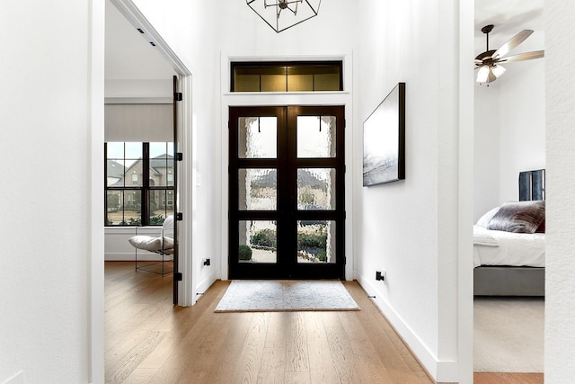 entrance foyer with french doors and wood-type flooring