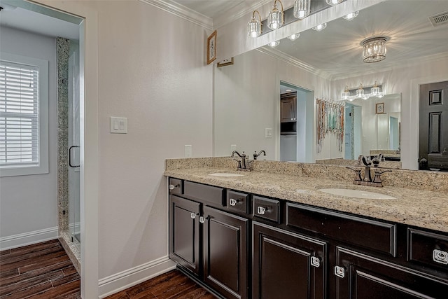 bathroom with vanity, hardwood / wood-style floors, crown molding, and walk in shower