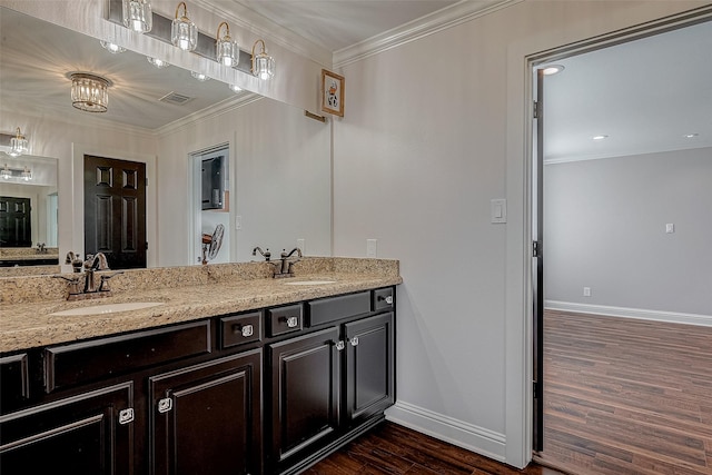 bathroom featuring hardwood / wood-style flooring, ornamental molding, and vanity