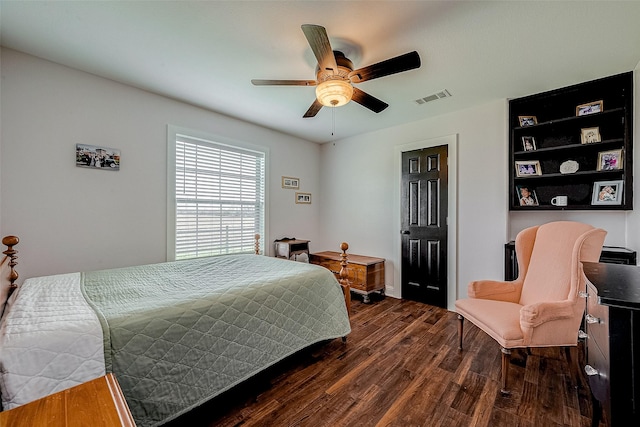 bedroom with ceiling fan and dark wood-type flooring