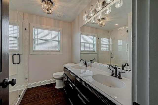 bathroom featuring toilet, vanity, hardwood / wood-style floors, and walk in shower