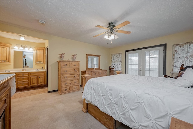 bedroom with light carpet, ensuite bath, access to exterior, a textured ceiling, and french doors