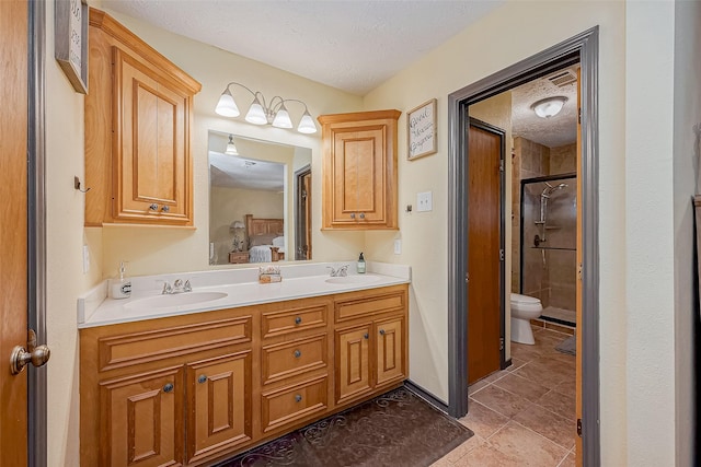 full bathroom featuring ensuite bathroom, a textured ceiling, toilet, a sink, and a shower stall