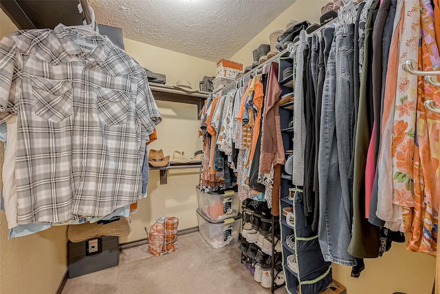 walk in closet with carpet