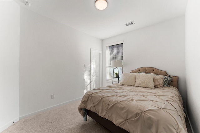 carpeted bedroom featuring visible vents and baseboards