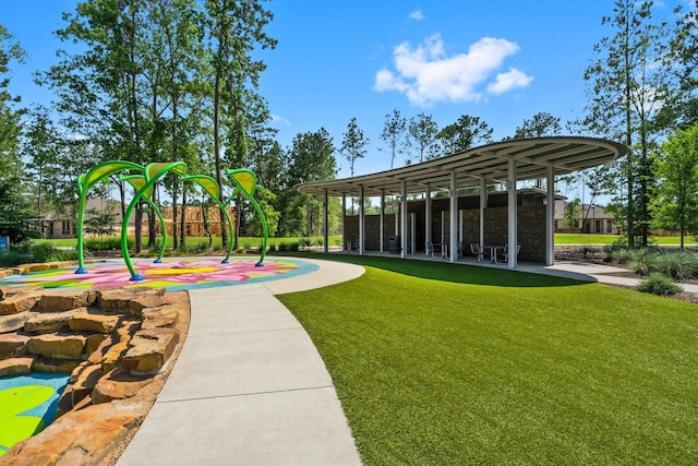 view of home's community featuring a lawn and playground community