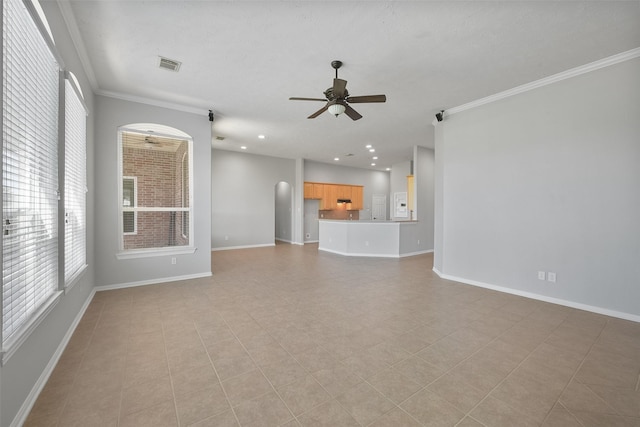 unfurnished living room with a ceiling fan, visible vents, ornamental molding, and baseboards