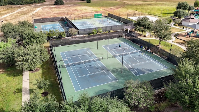 view of tennis court with a playground