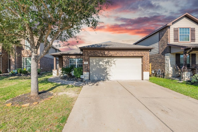 view of front of home featuring a garage and a yard