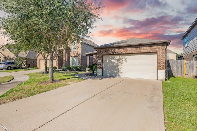 view of front of property with a garage and a yard