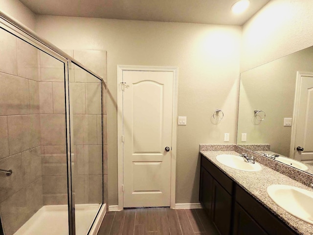 24827 Colony Meadow Trl, Houston, TX 77336 - full bathroom with a shower stall, wood finished floors, double vanity, and baseboards