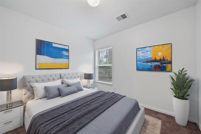 bedroom with dark colored carpet