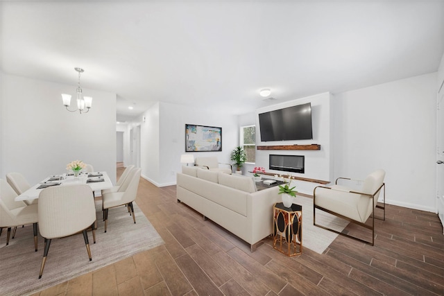 living room with a chandelier and dark hardwood / wood-style flooring