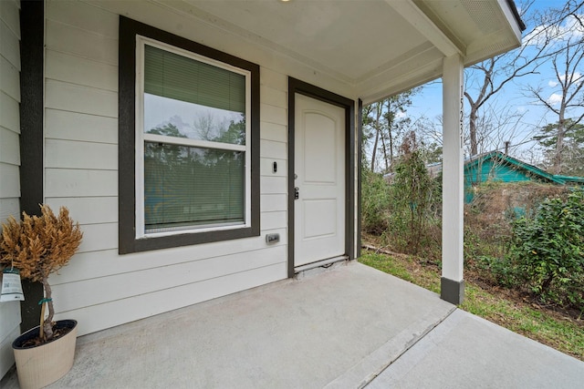 view of exterior entry featuring a patio area