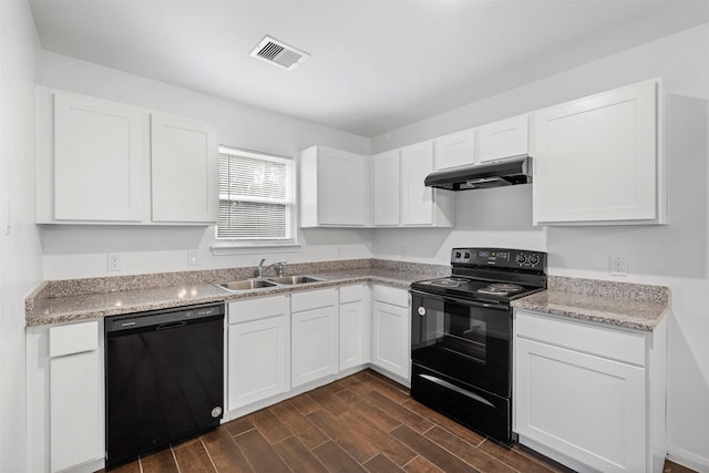 kitchen featuring sink, black appliances, white cabinets, and light stone counters