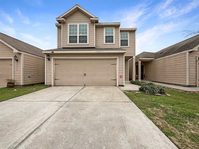 view of front facade featuring driveway, a garage, and a front lawn