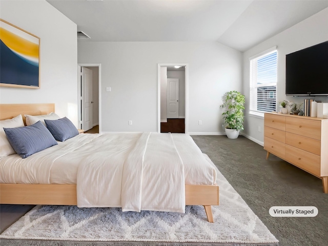 bedroom with baseboards, vaulted ceiling, visible vents, and dark carpet