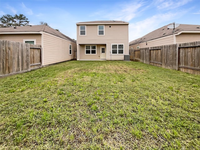 rear view of house featuring central AC, a lawn, and a fenced backyard
