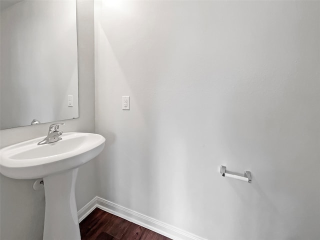 bathroom with baseboards and wood finished floors