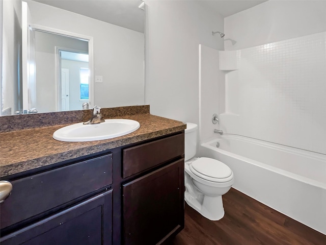 full bath with shower / tub combination, vanity, toilet, and wood finished floors