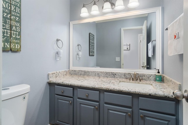 bathroom with toilet and vanity