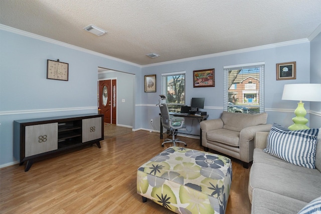 living room featuring crown molding, a textured ceiling, and hardwood / wood-style floors