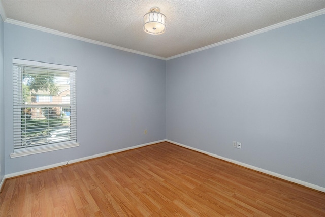 empty room featuring ornamental molding, light hardwood / wood-style floors, and a textured ceiling