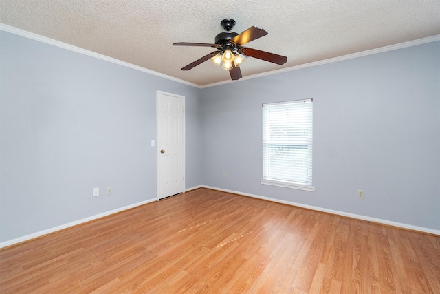 spare room featuring ornamental molding, light hardwood / wood-style flooring, a textured ceiling, and ceiling fan