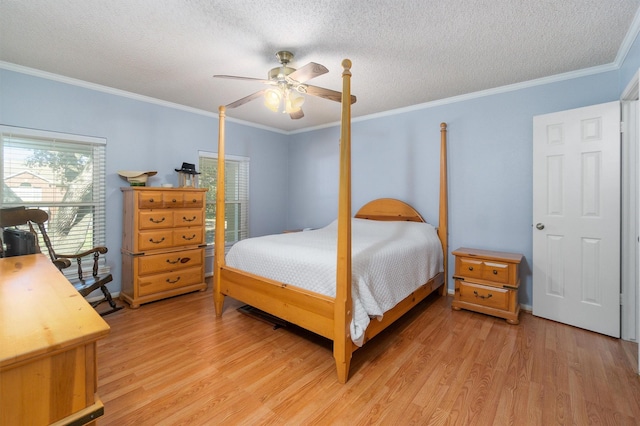 bedroom featuring ornamental molding, light hardwood / wood-style floors, and a textured ceiling